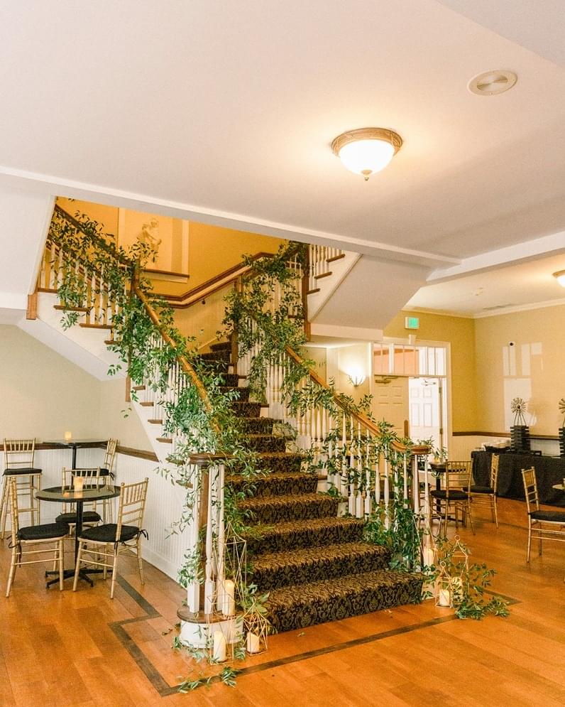 Wedding staircase decorated with greenery garlands.