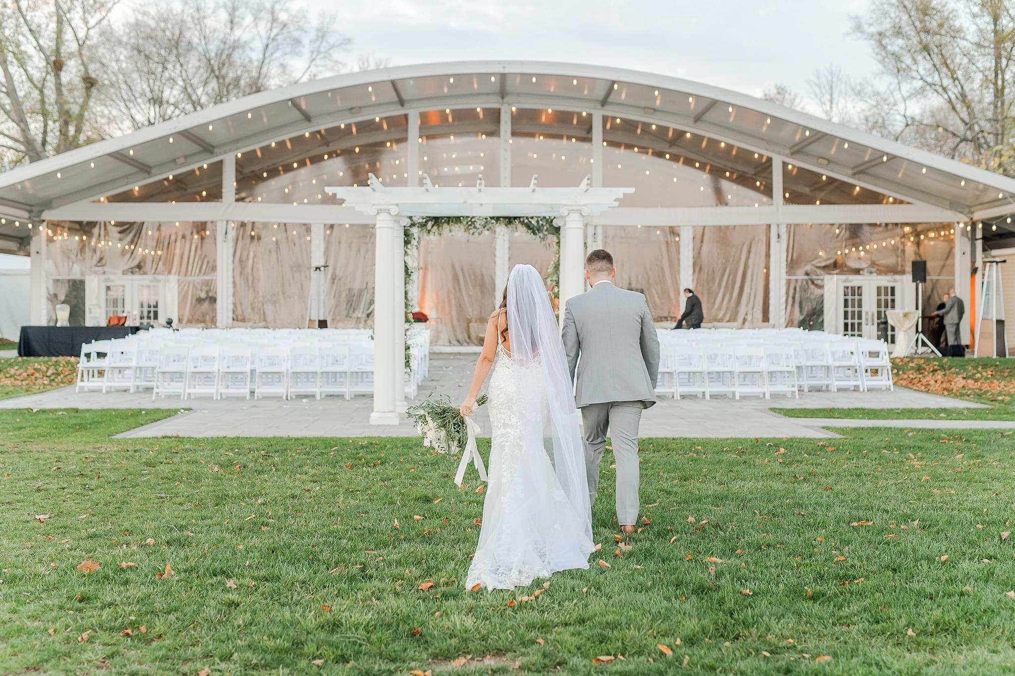 Bride and groom walking hand in hand after exchanging wedding vows at Pen Ryn Estate.