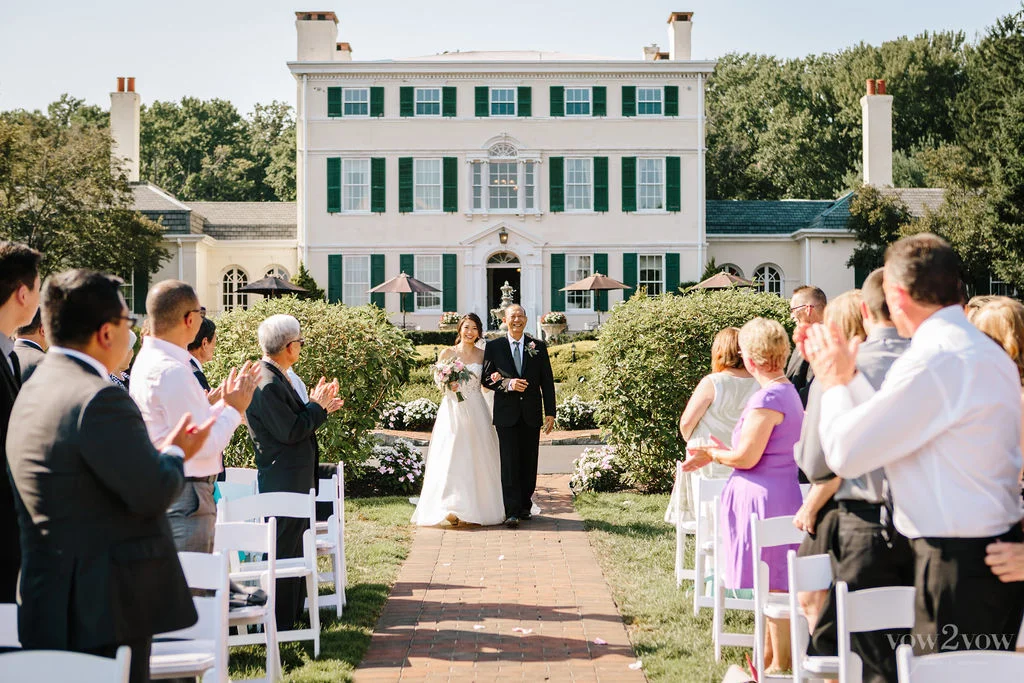 Bride and father walk down the isle at the historic Penryn Estate mansion